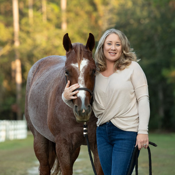 Bridgitte standing with a horse