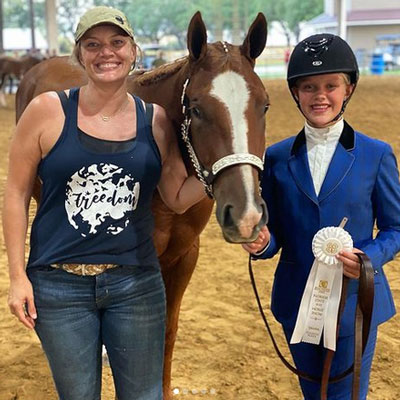 Sarah Craven and daughter standing with horse